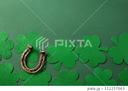 St. Patrick's day frame with clover leaves on green . St. Patrick's day frame with clover leaves on green . 112257063