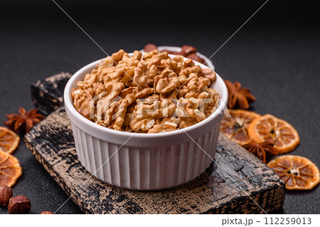 Delicious fresh peeled raw walnuts in a ceramic plate 112259013