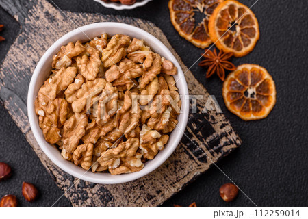 Delicious fresh peeled raw walnuts in a ceramic plate Delicious fresh peeled raw walnuts in a ceramic plate 112259014