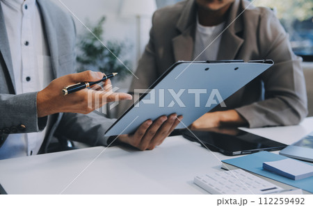 Young stressed Asian businessman working in the office. Businessman thinking too much work concept in the office. Young stressed Asian businessman working in the office. Businessman thinking too much work concept in the office. 112259492