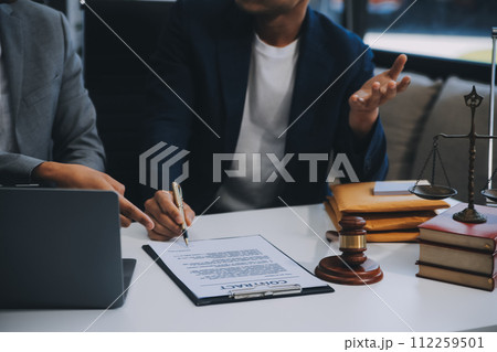 Consultation and conference of Male lawyers and professional businesswoman working and discussion having at law firm in office. Concepts of law, Judge gavel with scales of justice. Consultation and conference of Male lawyers and professional businesswoman working and discussion having at law firm in office. Concepts of law, Judge gavel with scales of justice. 112259501