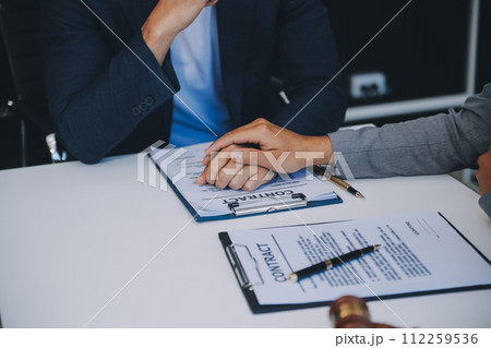 Consultation and conference of Male lawyers and professional businesswoman working and discussion having at law firm in office. Concepts of law, Judge gavel with scales of justice. 112259536