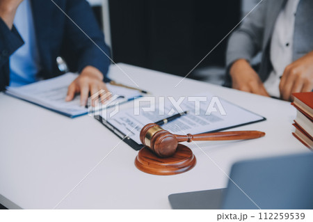 Consultation and conference of Male lawyers and professional businesswoman working and discussion having at law firm in office. Concepts of law, Judge gavel with scales of justice. 112259539