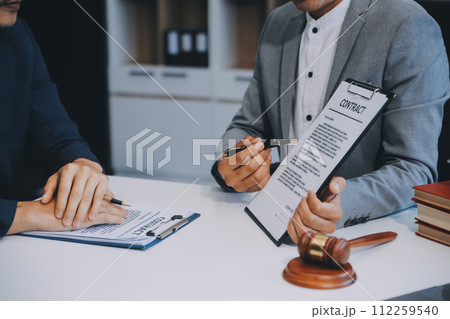 Consultation and conference of Male lawyers and professional businesswoman working and discussion having at law firm in office. Concepts of law, Judge gavel with scales of justice. 112259540