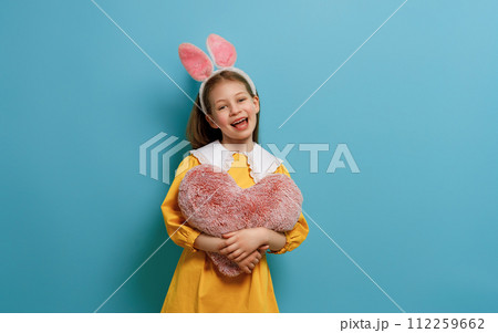 child wearing bunny ears on Easter day 112259662