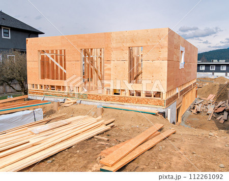 Wooden frame of a new house with engineered lumber materials in front 112261092