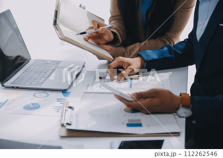 Business team working with new startup project plan and discussion information for financial strategy with laptop and digital tablet in a modern business lounge. 112262546