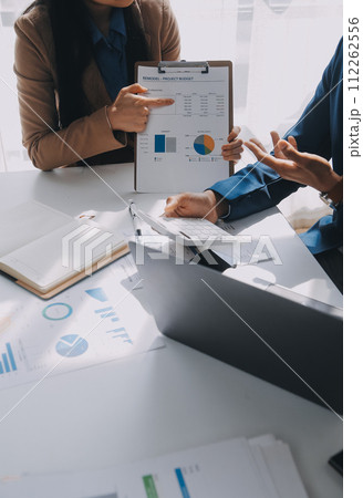 Business team working with new startup project plan and discussion information for financial strategy with laptop and digital tablet in a modern business lounge. Business team working with new startup project plan and discussion information for financial strategy with laptop and digital tablet in a modern business lounge. 112262556