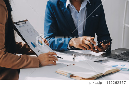 Business team working with new startup project plan and discussion information for financial strategy with laptop and digital tablet in a modern business lounge. Business team working with new startup project plan and discussion information for financial strategy with laptop and digital tablet in a modern business lounge. 112262557