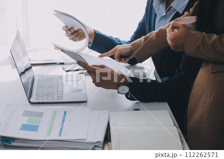 Business team working with new startup project plan and discussion information for financial strategy with laptop and digital tablet in a modern business lounge. 112262571