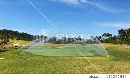 sprinkle on the golf course green sprinkle on the golf course green 112262953