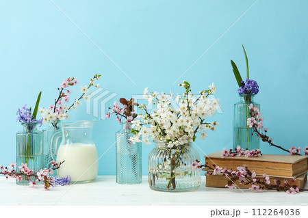 Spring twigs with flowers on a blue background. Spring twigs with flowers on a blue background. 112264036