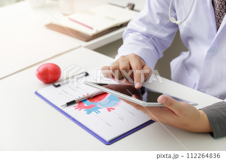 Doctor working with tablet computer at desk. Technology and medical concept. 112264836