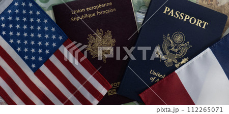 Flags of the United States and France passports on currency flat lay. Concept of business, trade, employment, vacation travel. Concept coming summer Olympics. Closeup, selective focus photo high Flags of the United States and France passports on currency flat lay. Concept of business, trade, employment, vacation travel. Concept coming summer Olympics. Closeup, selective focus photo high 112265071