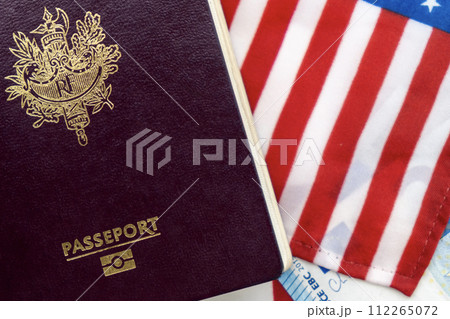 France passport on United States flag and Euro currency background. Concept of business, trade, employment, vacation travel. Concept coming summer Olympics. Closeup photo high quality photo. 112265072