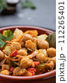 Ropa vieja, typical Canarian dish of chickpeas stew on earthenware casserole on dark table. Close up. Vertical format. 112265401