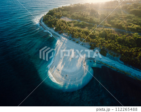 Maldives island with beach and sunrise sunshine. Aerial view of ocean coastline on Fuvahmulah island 112265488
