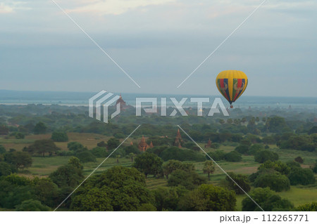 Balloons flying over Burmese temples of Bagan City from a balloon, unesco world heritage with forest trees, Myanmar or Burma. Tourist destination. 112265771