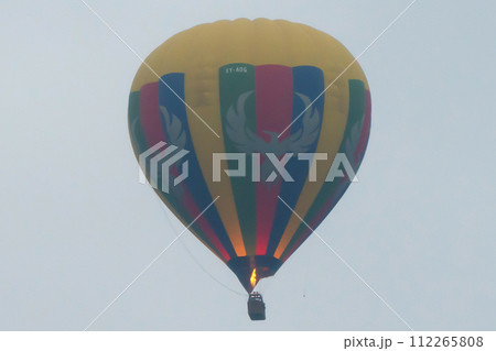 Balloons flying over Burmese temples of Bagan City from a balloon, unesco world heritage with forest trees, Myanmar or Burma. Tourist destination. Balloons flying over Burmese temples of Bagan City from a balloon, unesco world heritage with forest trees, Myanmar or Burma. Tourist destination. 112265808