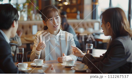 Coffee break. Group of young people sitting in a cafe and drinking coffee 112267537