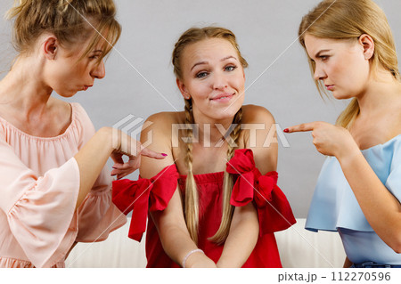 Woman being bullied by two females 112270596