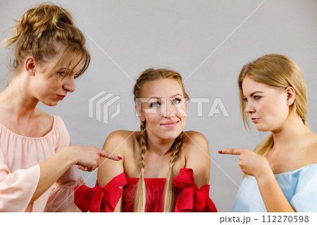 Woman being bullied by two females 112270598