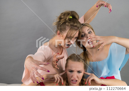 Woman being bullied by two females Woman being bullied by two females 112270664