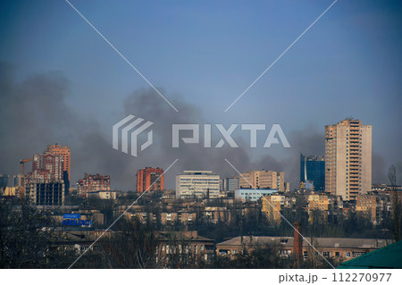 Armed conflict east Ukraine, Ukrainian war. Road sign with the inscription in Ukrainian - Donetsk, punched by bullets during the war in the Donbass, against broken military 112270977