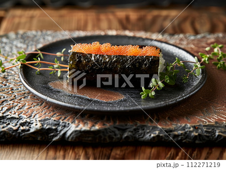 Japanese cuisine sushi on a black plate, set on a table 112271219