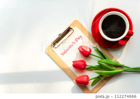 Valentine day. Red Lilly with red cup coffee on white background. Valentine day. Red Lilly with red cup coffee on white background. 112274666