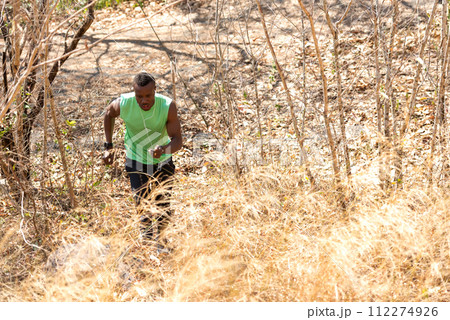 African man runner jogging and running trail in the meadow forest African man runner jogging and running trail in the meadow forest 112274926