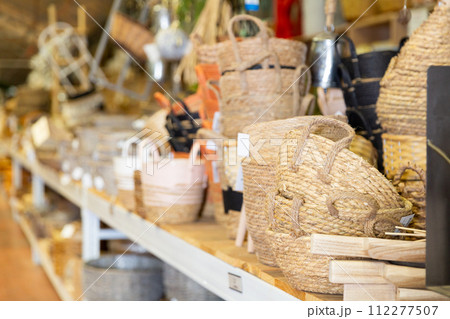 Wicker baskets and other handmade items on store shelves close up Wicker baskets and other handmade items on store shelves close up 112277507