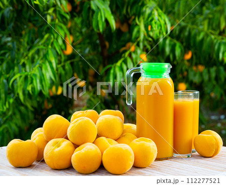 Freshly squeezed yellow peach juice with fresh fruits 112277521