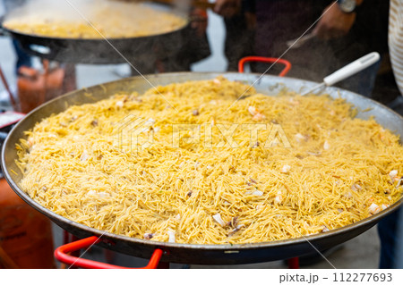 Cooking the Valencian dish Fideua de Marisco 112277693