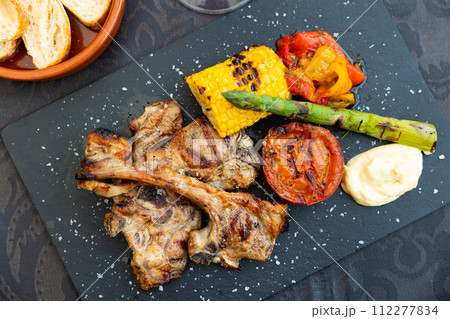 Roast lamb with corn, asparagus and steamed vegetables Roast lamb with corn, asparagus and steamed vegetables 112277834