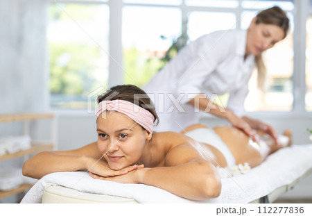 Young woman gets massage of her thighs and buttocks Young woman gets massage of her thighs and buttocks 112277836