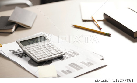 Desk with calculators for calculating, managing and analyzing economic profits and losses. Desk with calculators for calculating, managing and analyzing economic profits and losses. 112277861