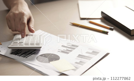 Desk with calculators for calculating, managing and analyzing economic profits and losses. Desk with calculators for calculating, managing and analyzing economic profits and losses. 112277862