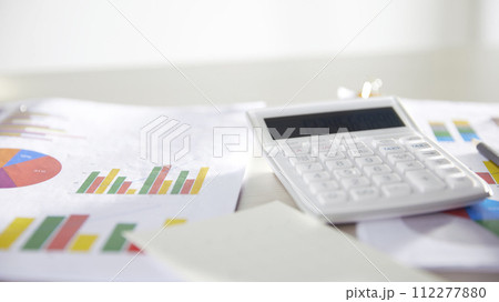 Desk with calculators for calculating, managing and analyzing economic profits and losses. Desk with calculators for calculating, managing and analyzing economic profits and losses. 112277880