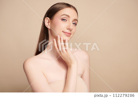 Beautiful young woman with clean fresh skin on beige background, Face care, Facial treatment, Cosmetology, beauty and spa, women portrait. 112279286