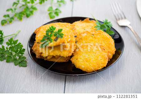 fried vegetarian potato pancakes in a plate. fried vegetarian potato pancakes in a plate. 112281351