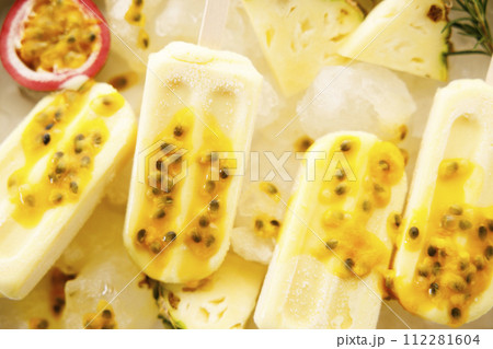 Pineapple popsicles with fresh passion fruit in ice tray. Pineapple popsicles with fresh passion fruit in ice tray. 112281604