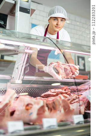 Male meat vendor provides selection Male meat vendor provides selection 112283201