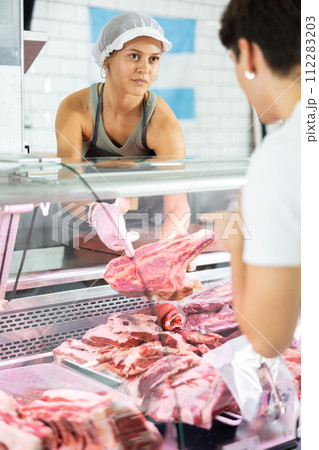 female butcher skillfully presents female butcher skillfully presents 112283203