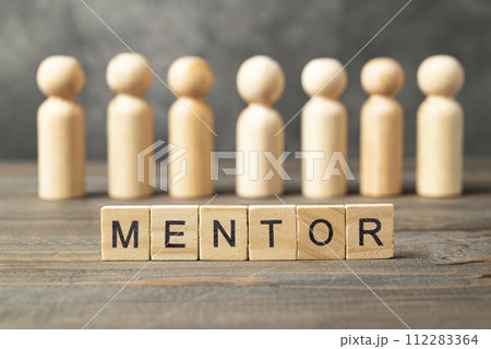 The row of wooden cubes with 'mentor' text and a wooden peg doll 112283364