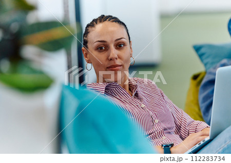 A modern programmer discussing future business projects with colleagues in a modern startup office 112283734