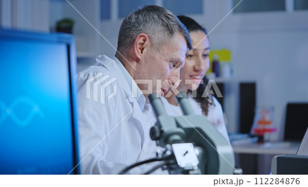 Excited laboratory workers looking at work results, successful project completion 112284876