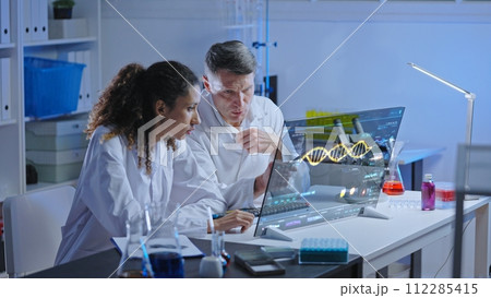 Unhappy lab scientists looking at dna structure on screen, experiment failure Unhappy lab scientists looking at dna structure on screen, experiment failure 112285415