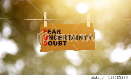Paper hanging on the rope with 'Fear Uncertainty Doubt' text Paper hanging on the rope with 'Fear Uncertainty Doubt' text 112285889