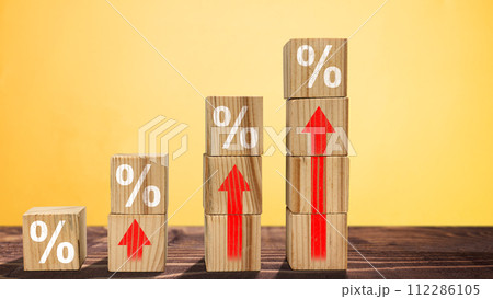Stack of wooden cubes with the symbol of rising inflation rate graph arrow 112286105